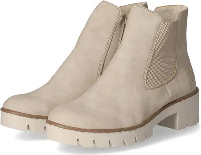 A pair of beige Chelsea boots with a thick sole and elasticated side panels, shown against a white background.