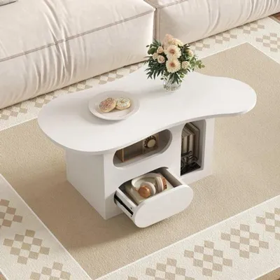 Image de Table basse - forme organique - blanche - avec tiroirs et compartiments de rangement ouverts - design moderne