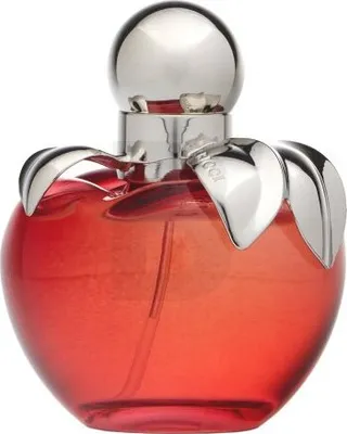 A studio shot of a red apple-shaped perfume bottle with a silver cap and leaf-like accents.