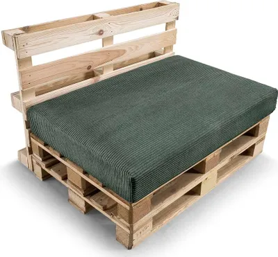 A green cushion on a wooden pallet sofa.