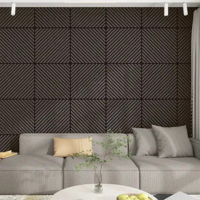A living room scene with a sofa and a wall covered in acoustic panels.