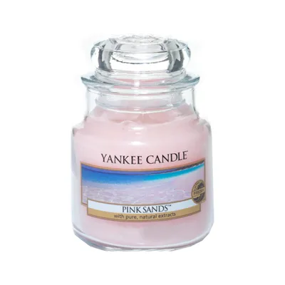 A Yankee Candle Pink Sands scented candle in a glass jar with a lid.