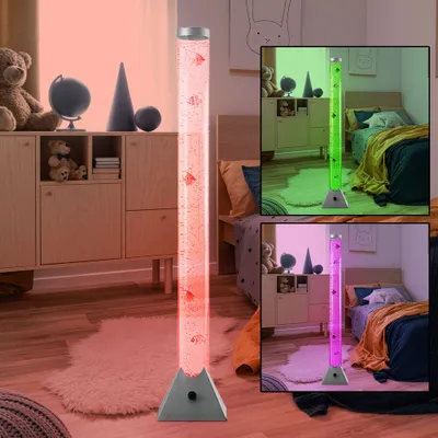 A floor lamp with decorative fish in a water tube, shown in different lighting colors in a bedroom setting.