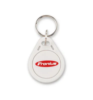 A white key fob with a red logo is shown.