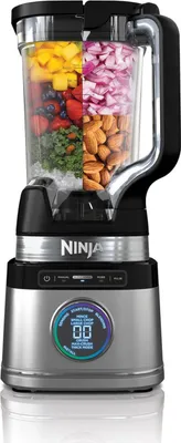 A Ninja stand mixer with a transparent pitcher filled with various ingredients.