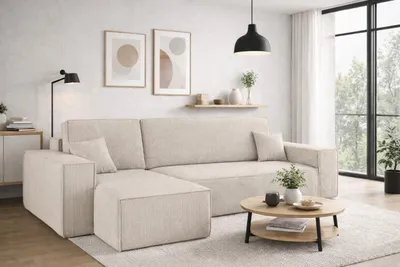 A modern living room with a beige sectional sofa, coffee table, and artwork.