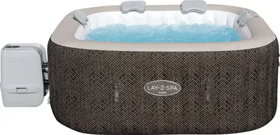 An inflatable hot tub filled with blue water, with a control unit attached to the side.