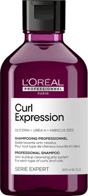 A studio shot of a purple shampoo bottle.
