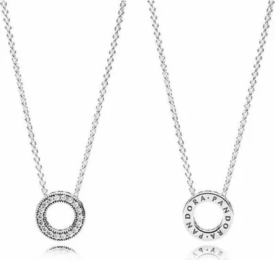 Two silver necklaces with circular pendants on a white background.