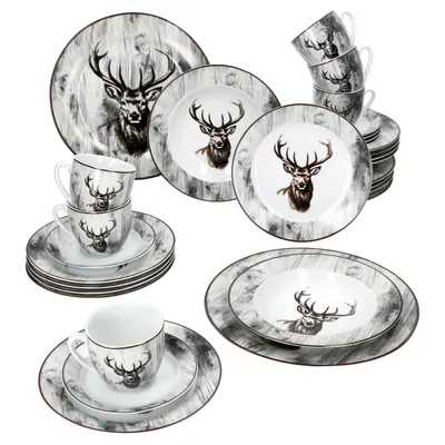 A collection of dinnerware with a stag motif, including plates, bowls, and cups, arranged on a white background.