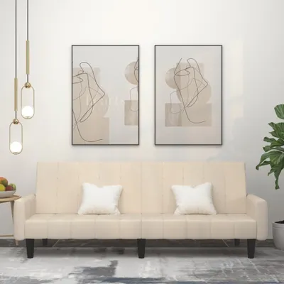 A cream-colored sofa is displayed in a room with abstract art on the wall and a plant in the corner.