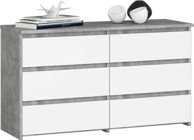 A modern chest of drawers with a concrete-effect top and sides, and white drawers.