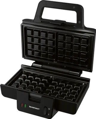 An open black waffle maker with its interior waffle grid visible.