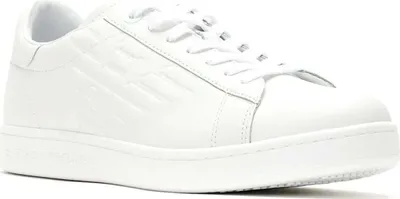 A close-up, side view of a white sneaker.