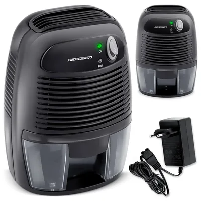 A black electric dehumidifier with its power adapter is displayed against a white background.