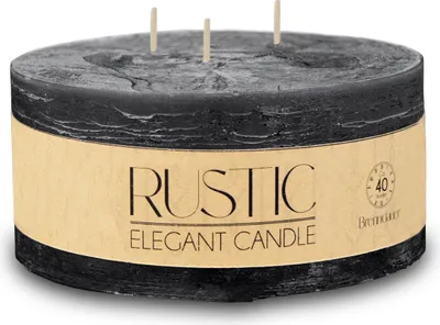A black, cylindrical candle with a tan label.