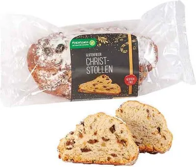 A packaged gluten-free Christstollen with two slices shown in the foreground.