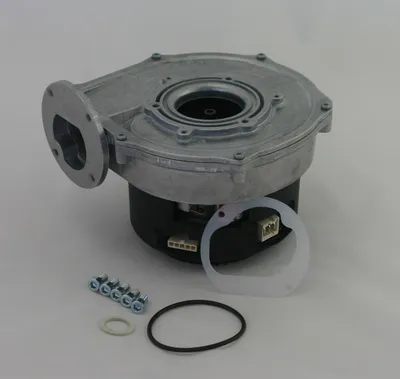 A product shot of a blower assembly with accompanying parts on a white background.