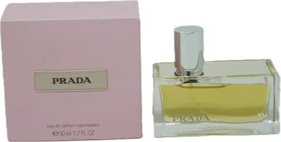 A product shot of Prada Amber Eau de Parfum for women, with its pink box and clear glass bottle.