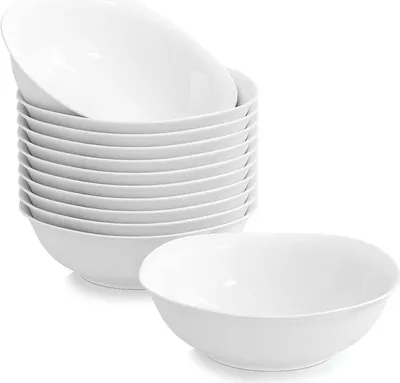 A stack of white ceramic bowls and one bowl in the foreground.