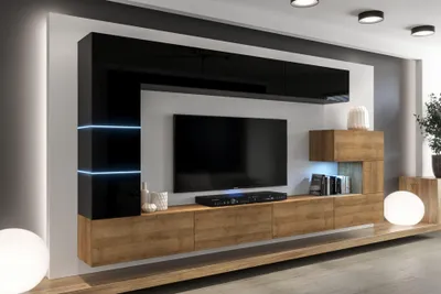 A modern living room wall unit with a television and integrated shelving.