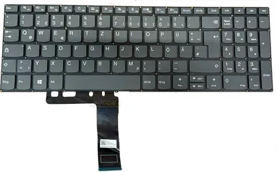A top-down view of a laptop keyboard with a ribbon cable attached.