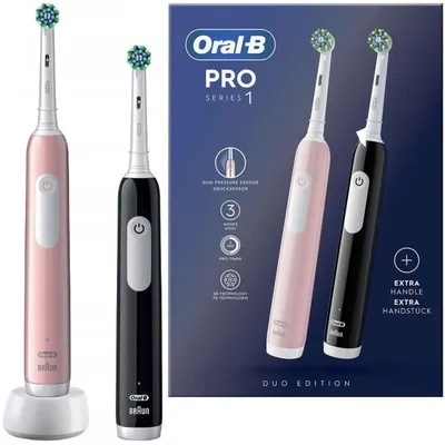A product shot of two Oral-B Pro 1 electric toothbrushes, one pink and one black, displayed next to their packaging which highlights product features.