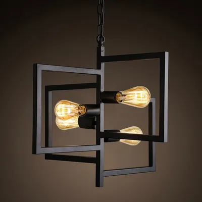 A black metal chandelier with four Edison-style bulbs.