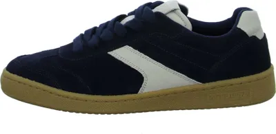 A side view of a navy blue low-top sneaker with a white stripe and a tan sole.