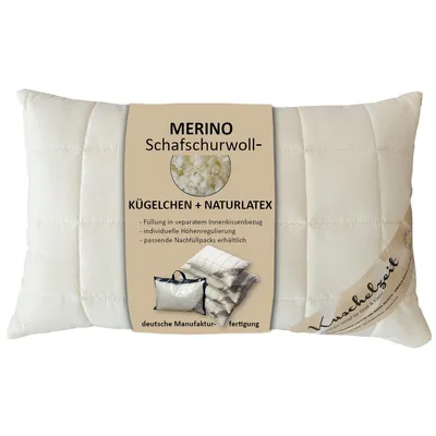 A white pillow with a beige label attached.