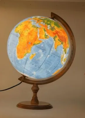 A lit globe on a wooden stand.