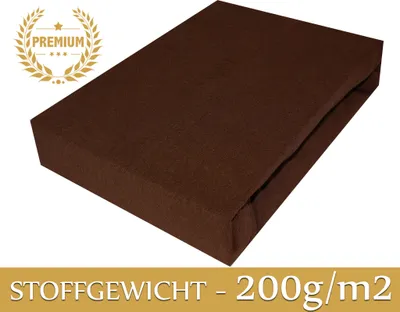 A brown rectangular object, likely a folded sheet or fabric, is presented on a white background. A golden laurel wreath with the word "PREMIUM" is visible in the top left corner, and text indicating "STOFFGEWICHT - 200g/m2" is displayed at the bottom.