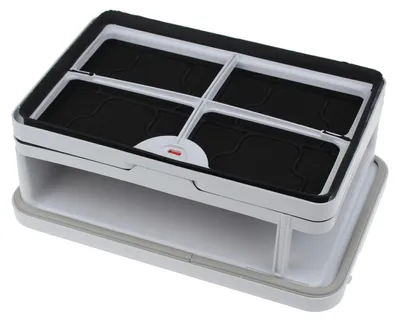 A white and gray appliance part with black inserts, shown from a slightly elevated angle against a white background.