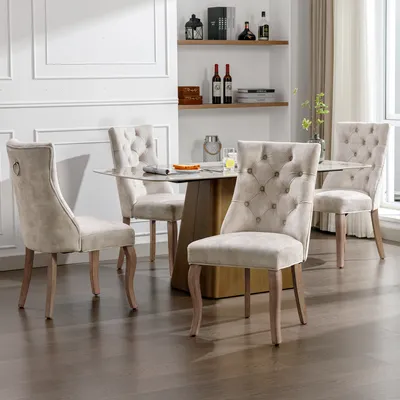 A dining set with four chairs around a table in a well-lit room.