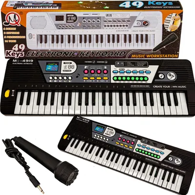 A product shot of an electronic keyboard and microphone set, with packaging visible.