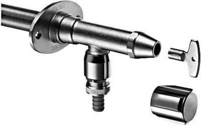 A close-up studio shot of a frost-proof outdoor wall valve set with a key and cap.