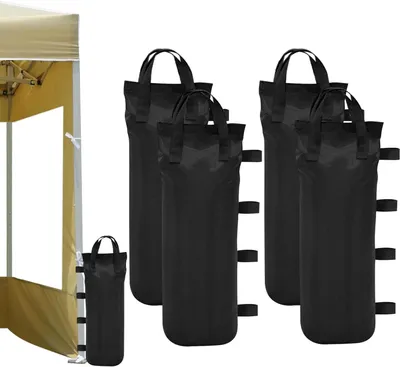 A partial view of a tan canopy tent is on the left, and several black sandbags are arranged on the right.