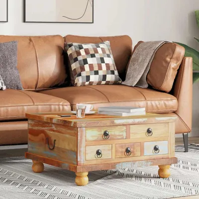 A coffee table in a living room setting, placed in front of a leather couch.