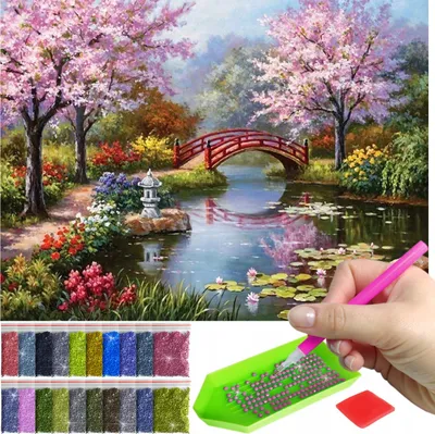 A diamond painting kit with a landscape image and accessories.