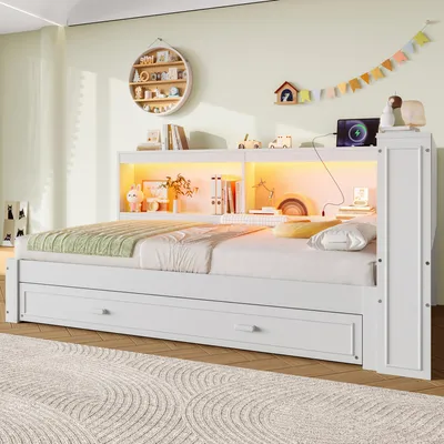 A white bed with storage drawers and a lighted headboard in a bedroom.