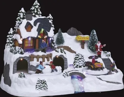 A festive Christmas village scene with Santa, children building a snowman, and a house.