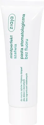A white tube of toothpaste with green text and branding.
