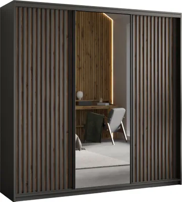 A modern wardrobe with sliding doors, featuring a mirrored section and wooden slats, reflecting a room with a chair and desk.