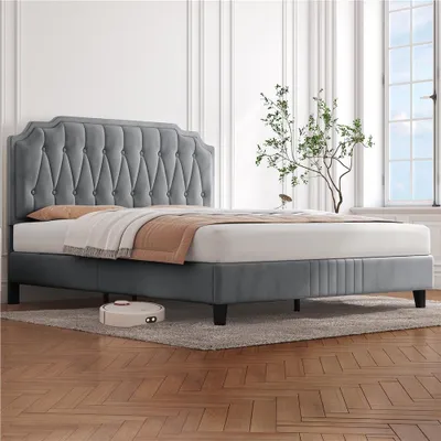 A bed in a well-lit room with a window and a plant.