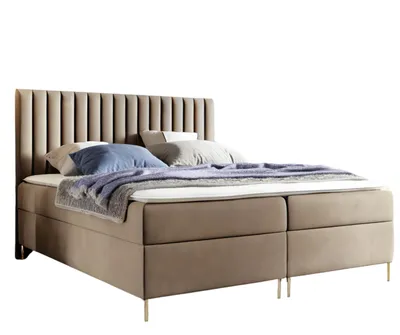 A bed with a headboard and pillows on a white background.