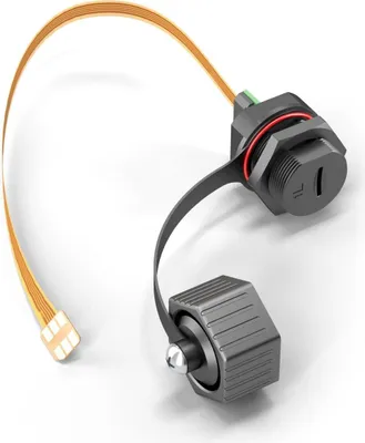 A close-up studio shot of a black electronic connector with a flexible orange cable attached, against a white background.