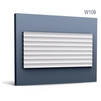 A white decorative wall panel with a ribbed texture is mounted on a dark blue wall.