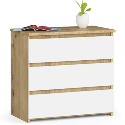 A modern chest of drawers with a wood-grain frame and white drawers, topped with a book and a small potted plant.