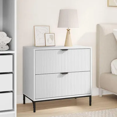 A white nightstand with two drawers is shown in a bedroom setting, next to a bed and a closet.