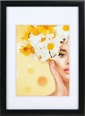 A framed portrait of a woman with flowers in her hair.